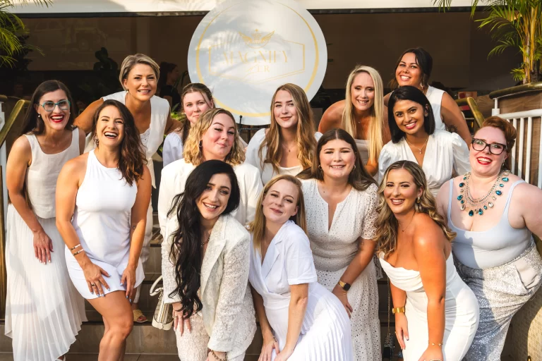 Group of Magnify Her Award finalists all dressed in stunning white outfits, posing at the Finalists in Focus 2024 Event.