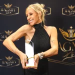 Winner of 2024 Magnify Her Business Woman of the Year Awards - Grace Kelly holding her trophy.