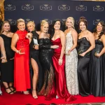 Magnify HER 2024 Gala Awards Night - Group photo at Darwin's largest celebration for women in business NT - Group photo. 9 ladies holding their awards and co-founders Peta and Caitlyn.